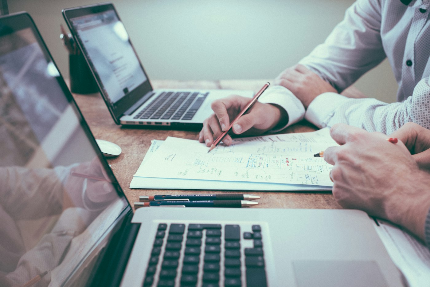 Documents, forms and record-keeping tools on a desk, representing internal controls and compliance records (illustrative image)